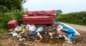 Waste dumped in the countryside, an illegal social issue, fly tipping causing environmental pollution